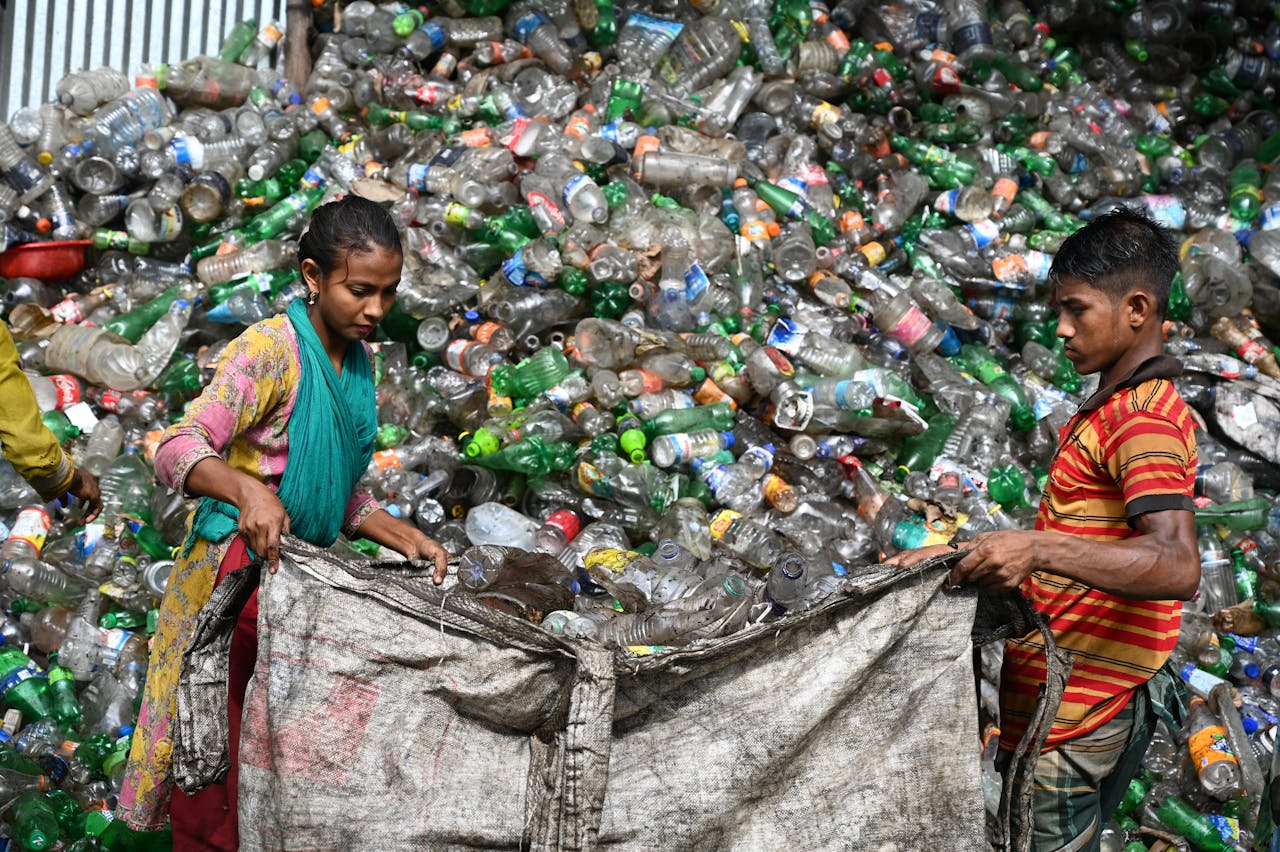 Mastering the First Impression: Your intriguing post title goes here Workers sorting plastic bottles at a recycling facility in Chattogram, Bangladesh.
